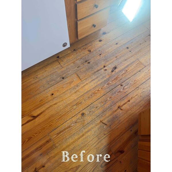 Wood plank floor with visible grain and knots beside a wooden cabinet, stamped Before