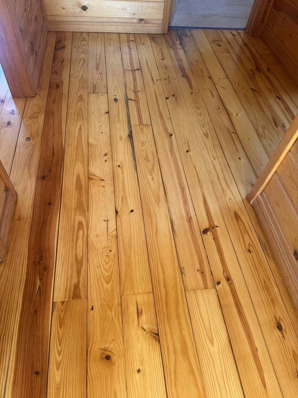 The same heart pine floor sanded and clear coated to a clean natural finish