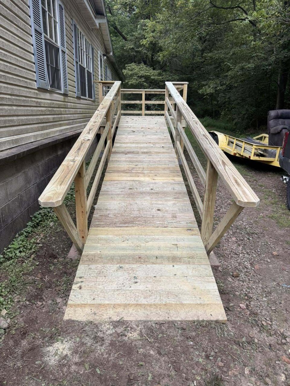 A new code built pressure treated wheelchair access ramp with handrails